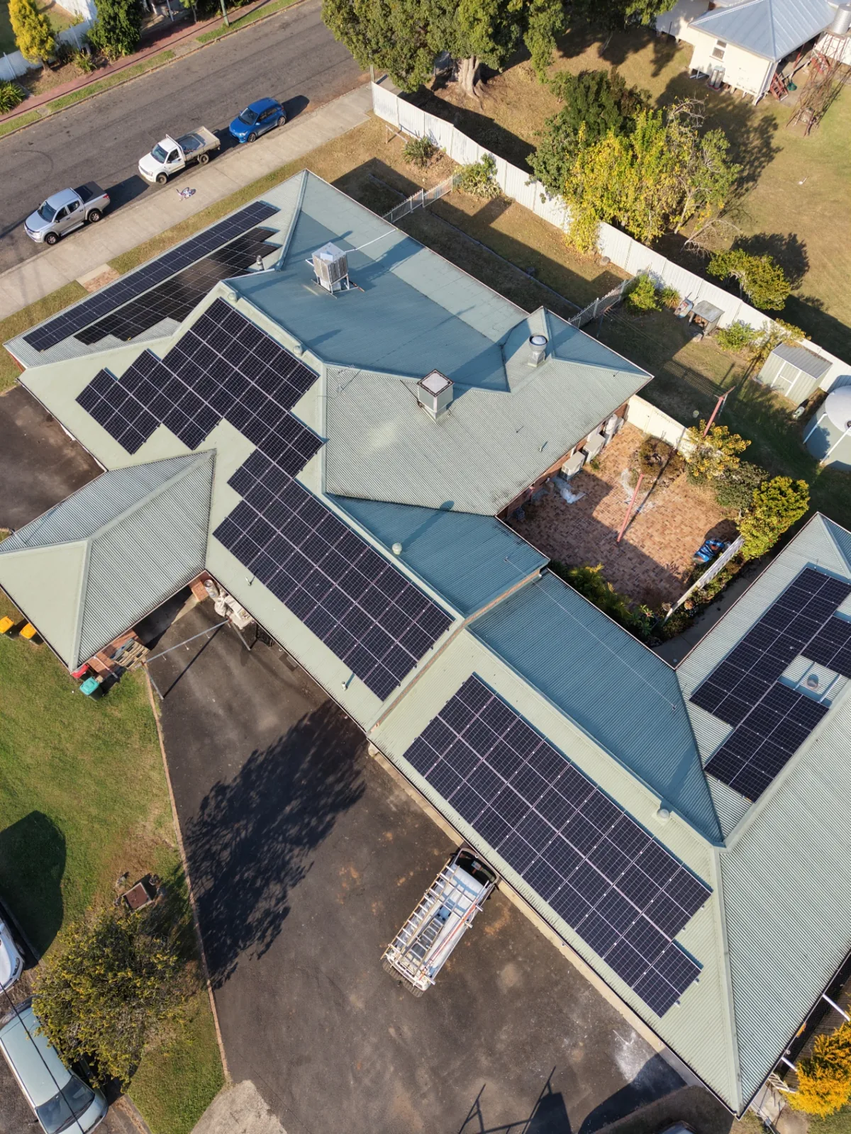 Aerial drone view of the Dog N' Bull Hotel with solar panels across every roof section, Bonalbo NSW