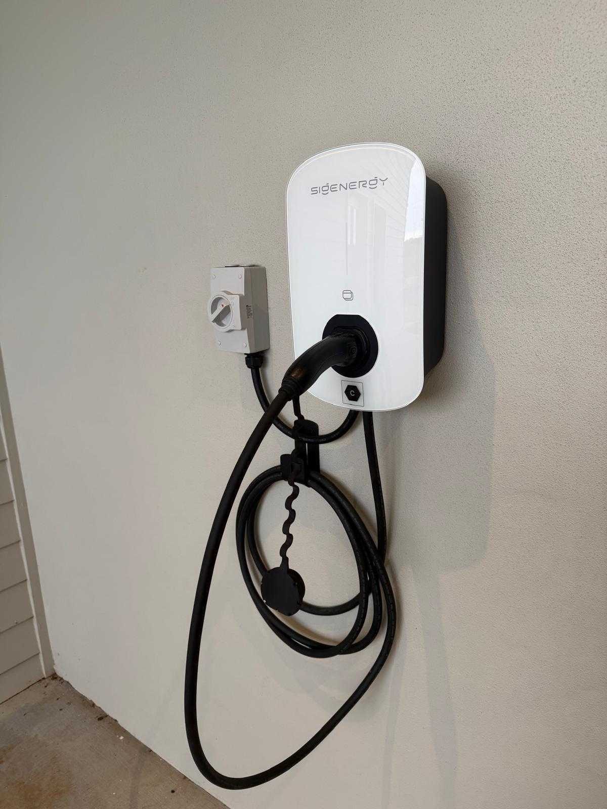 SigEnergy EV charger installed by HJP Electrical on a home wall, plugged in and ready to charge